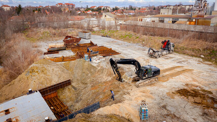 Aerial view on excavator and tow truck as they move part of vessel