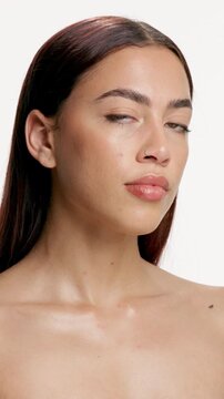 Face, natural skincare and hair care with woman in studio for dermatology, cosmetology or texture. Portrait, cosmetics and model with confidence, beauty or wellness with hairstyle on white background