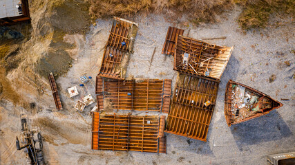 Aerial view on workers as they manually cutting old ship with blowtorch, mixing oxygen and...