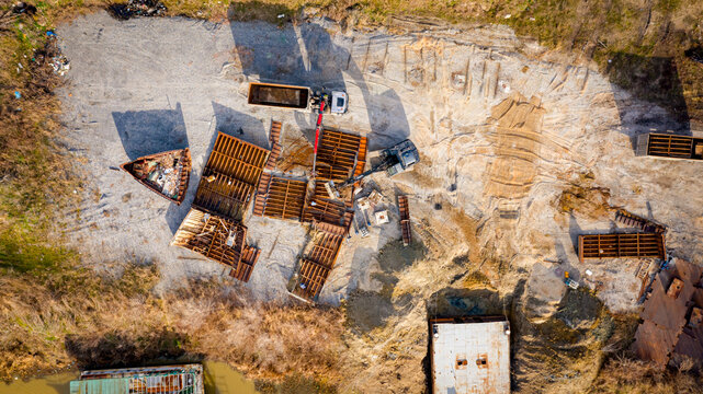 Aerial view on collecting, loading waste steel into a truck container for transportation