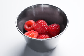 Fresh raspberries in round metal container