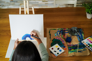 Female kid painting at home - Education without technology, art and creativity for children concept - Main focus on right hand