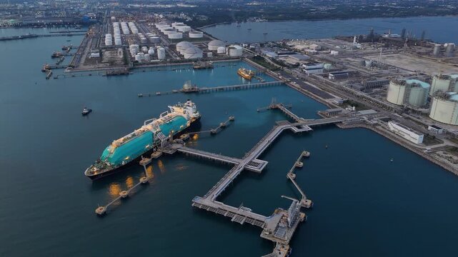 LNG (Liquified Natural Gas) tanker anchored in Gas terminal gas tanks for storage. Oil Crude Gas Tanker Ship. LPG at Tanker Bay Petroleum Chemical or Methane freighter export import transportation