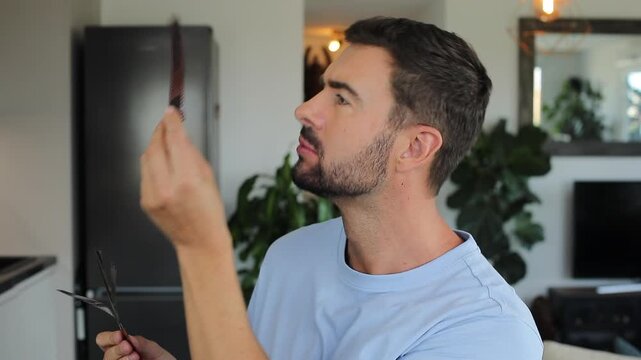 Photographer examining analog retro film at home  - Powered by Adobe