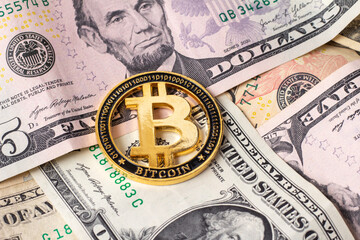 Bitcoin on the background of dollar bills