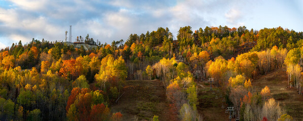 A panoramic view of a ski montain in the fall colors