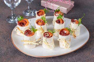 Appetizer from pita bread in shape of roses with tomato, sausage and cheese