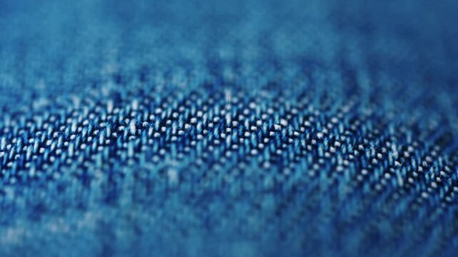 Close up of blue denim fabric texture showing fine threads and detailed textile pattern