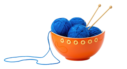 Isolated orange bowl with blue yarn balls and knitting needles against a light surface
