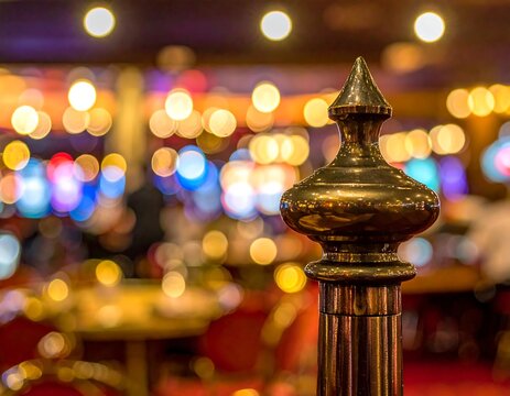 A shiny, golden post finial with bokeh lights in the background
