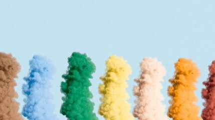 Colorful smoke clouds in pastel tones on light blue background, creative abstract composition