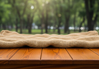 Wooden Table with Burlap Cloth and Green Nature Background