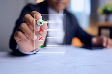 check list concept with businessman using pen to tick check mark on virtual interface to mark sign correct and wrong in item list represent to document assessment follow up and examination test
