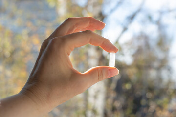 Close-up of Woman's Hand Holding Pill Capsule