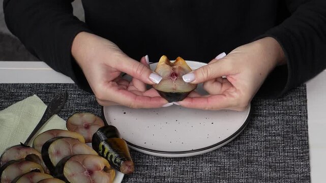 Smoked mackerel close-up. Delicious smoked fish close-up, the process of preparing it for eating. Cold-smoked fish.