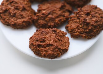 Close-up shot of a white plate with homemade cookies on it.