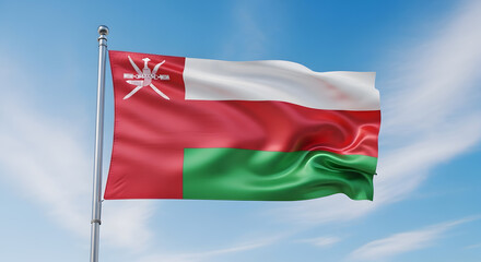Oman's National Flag Waving Majestically Against a Bright Blue Sky with Wispy Clouds