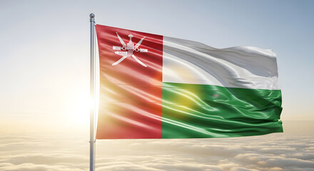 Oman National Flag Waving Proudly Against a Bright Sunny Sky with Soft Clouds Below