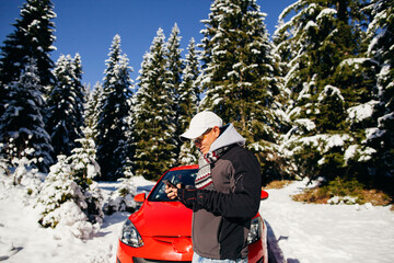 man travel by car in mountains winter time. Man using rental car for travel in winter snow forest