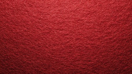 Close up textured background of deep rich red fabric or carpet with a soft fuzzy surface and subtle light variations