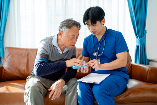 asian senior man consult supplement medicine vitamin and drug instructed by physiotherapist. home caregiver nurse visit retirement patient for health check up recovery process medical service