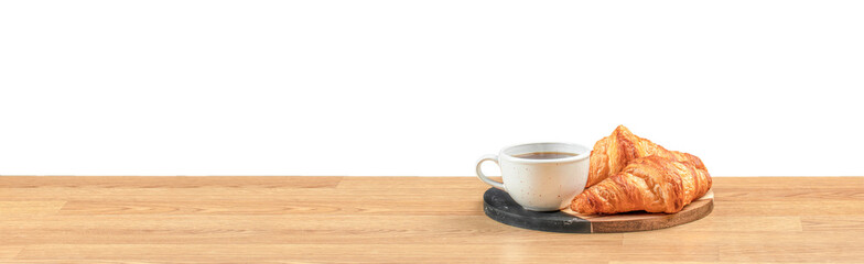 Minimalist morning concept with hot coffee and fresh croissants on a wooden table, symbolizing comfort, relaxation, and breakfast simplicity with space for text or design