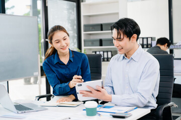 Young Asian professionals collaborating in modern office, discussing business strategy, teamwork, and success. Perfect for corporate, startup