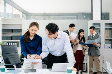 Group of Asian business meeting in planning design in creative business discussing work in the office