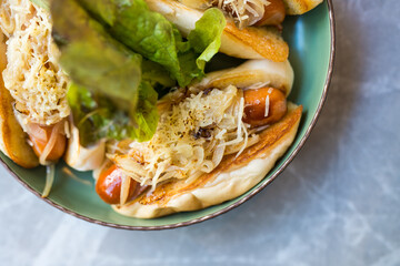 A bread filled sausage served on dish. Top view