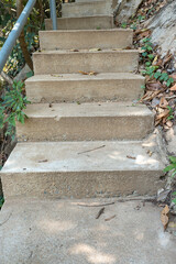 Old concrete stairs to mountain. Worn stone steps in forest. Rough texture of aged cement surface. Grunge look for design.