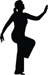Silhouette of a Woman in a Graceful Dancing Pose with One Leg Raised