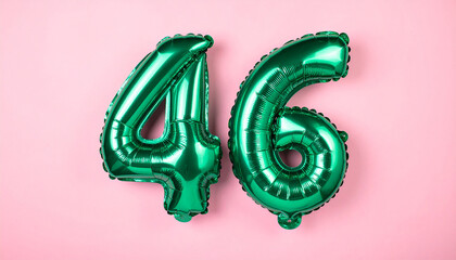 Floating shiny green foil balloon number 46 in pink backdrop, soft glowing light.