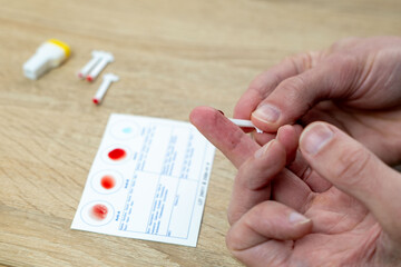 Blood typing test being performed, showing results on card, focusing on health and diagnostics,...