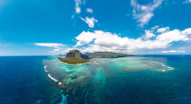 Le Morne Brabant Mauritius aerial panorama of turquoise lagoon coral reef surf lines and deep blue ocean sky