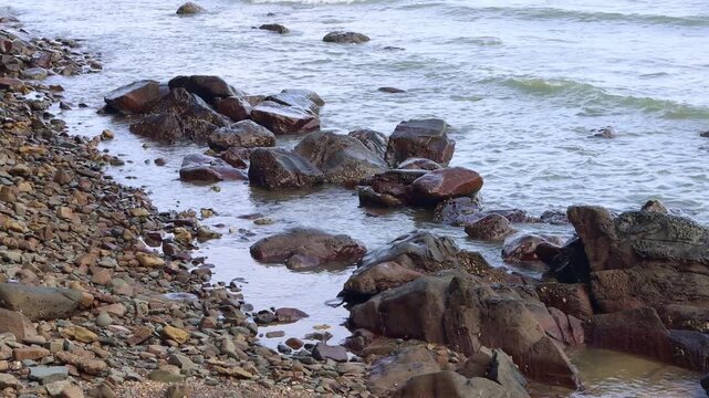 wave of the sea is hitting rocks at the bay of the sea 
