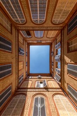 Florence, Italy - July 27, 2025: The inner space of a building in Florence that opens to the sky, framed by the walls of the courtyard.