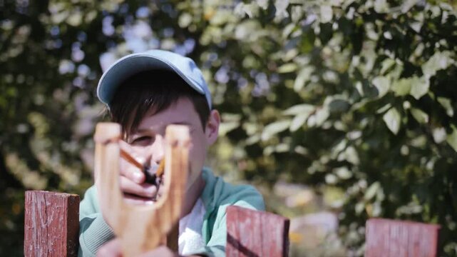 Summer Sunshine Adventures: Boy Having Fun with Slingshot Outdoors
