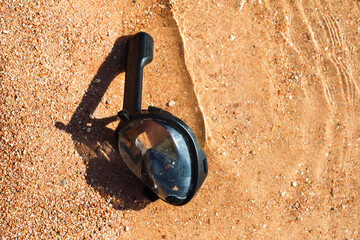 snorkeling mask floats in the water on the sandy shore of the Red Sea, inviting adventurers to explore the underwater wonders.