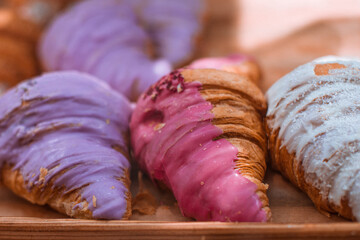Delicious sweet croissants with raspberry and berry topping on the cafe counter