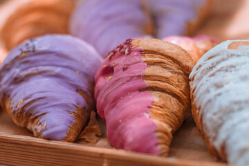 Delicious sweet croissants with raspberry and berry topping on the cafe counter