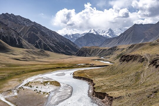 Mountain river in a valley, picturesque mountain landscape with white mountain peaks, Tian Shan Mountains, Issyk-Kul, Kyrgyzstan