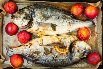 Roasted whole sea bream fish or dorado, close up.