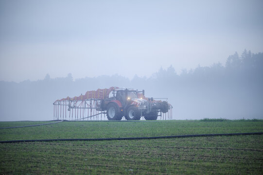 Farmer with tractor fertilising, Rottenschwil, Canton Aargau, Switzerland