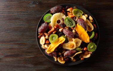 Dried tropical fruits with various nuts and raisins.
