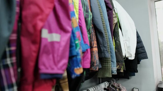 Vintage clothing store with rows of colorful second hand clothes, sustainable fashion, slow consumption, and thrift shop lifestyle concept