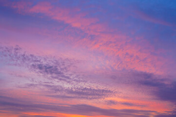 Beautiful sunset or sunrise sky with vibrant clouds changing from purple to orange is perfect for an abstract or nature background.