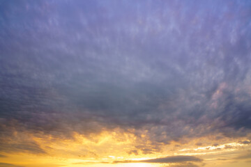 Beautiful colorful evening or morning fluffy clouds in sky. Blue and yellow cloudscape at sunset or sunrise. Nature background.