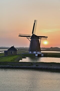 Historic windmill in the light of the setting sun, De Traanroeier, Het Noorden Molen, Texel, North Holland, Netherlands