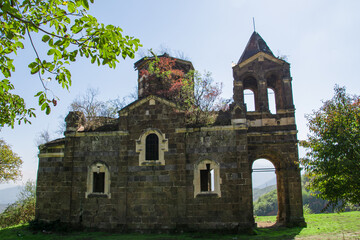 Fototapeta premium An old church in nature. A Greek church in Armenia. The architecture of an old monastery. An old temple with beautiful architecture. Beautiful nature