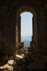 Fototapeta premium An old church in nature. A Greek church in Armenia. The architecture of an old monastery. An old temple with beautiful architecture. Beautiful nature